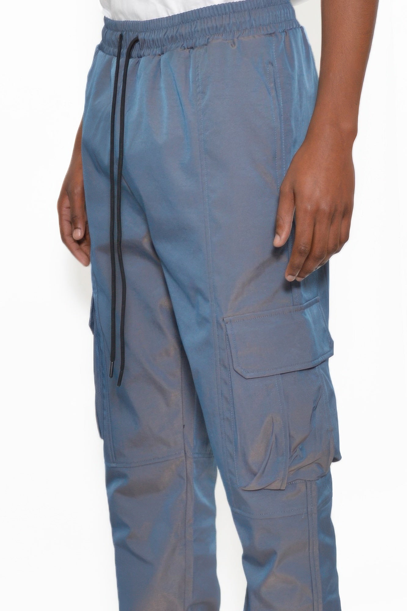 Blue jogger cargo pants close-up: drawstring waist, cargo pocket, cuffed hem