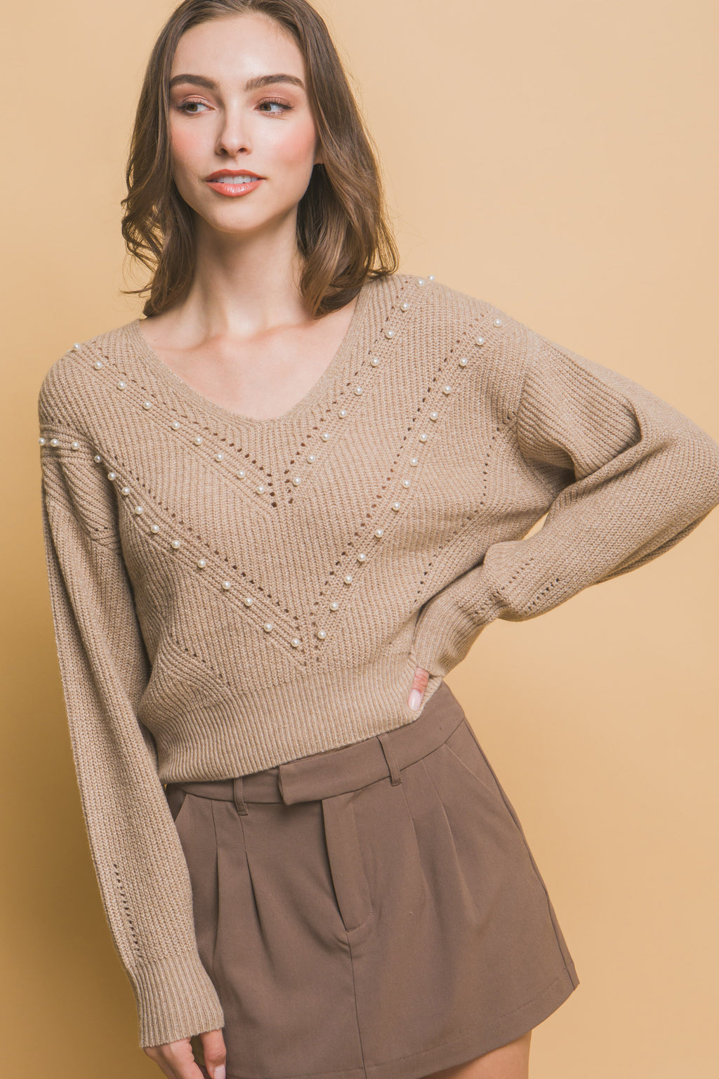 Khaki knit sweater with pearl beading V-neck and chevron-like diagonal lines