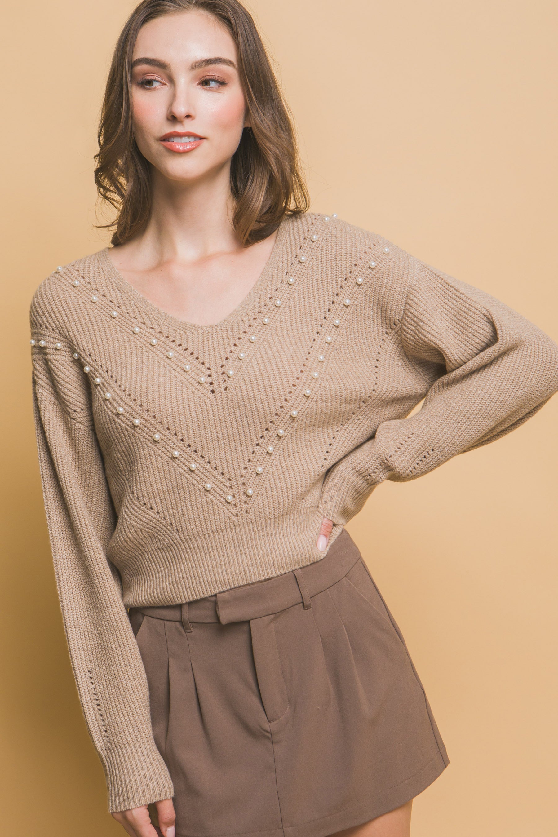 Khaki knit sweater with pearl beading V-neck and chevron-like diagonal lines