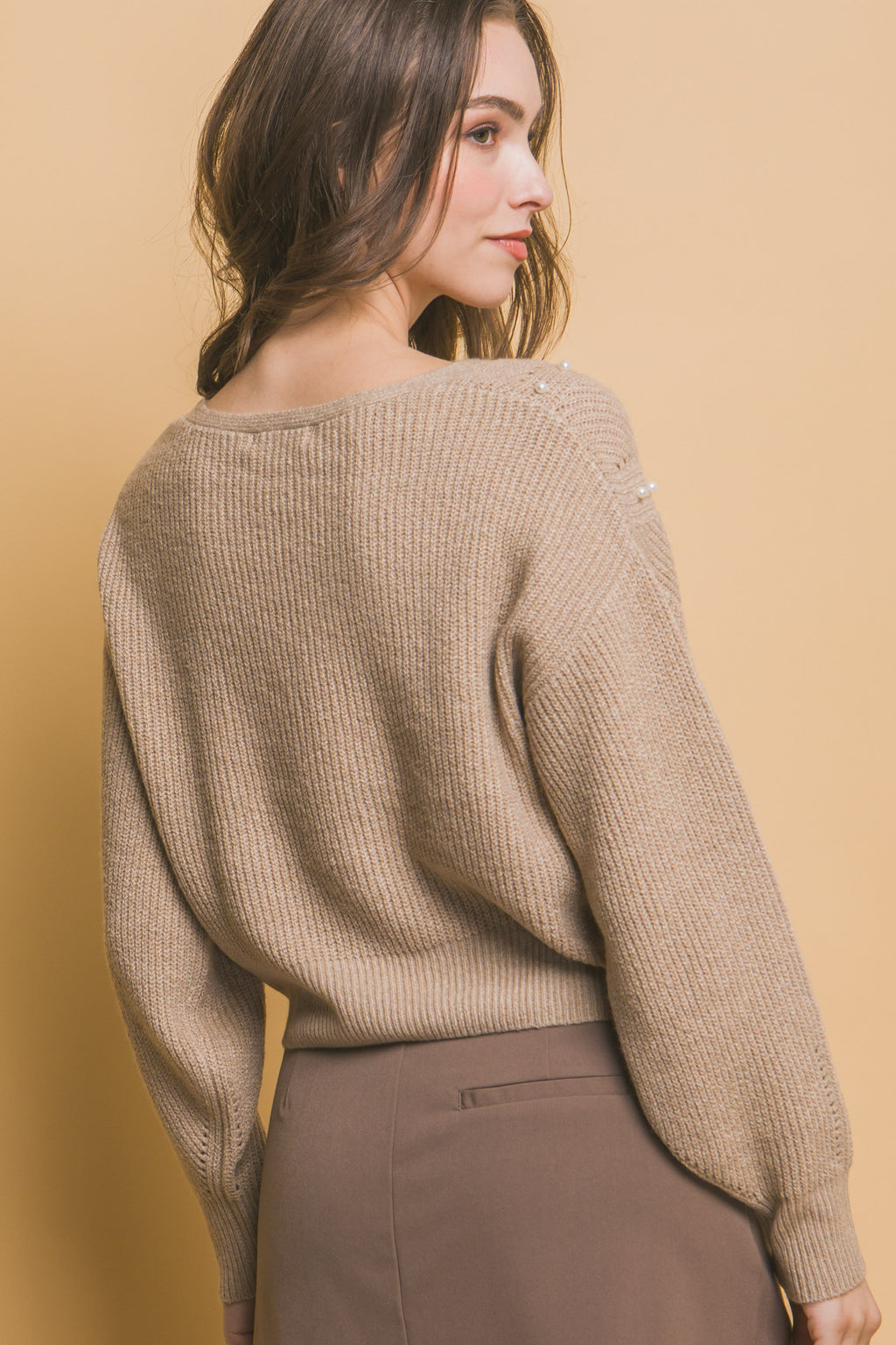 Khaki pearl detail knit sweater, long sleeves, back view with ribbed hem