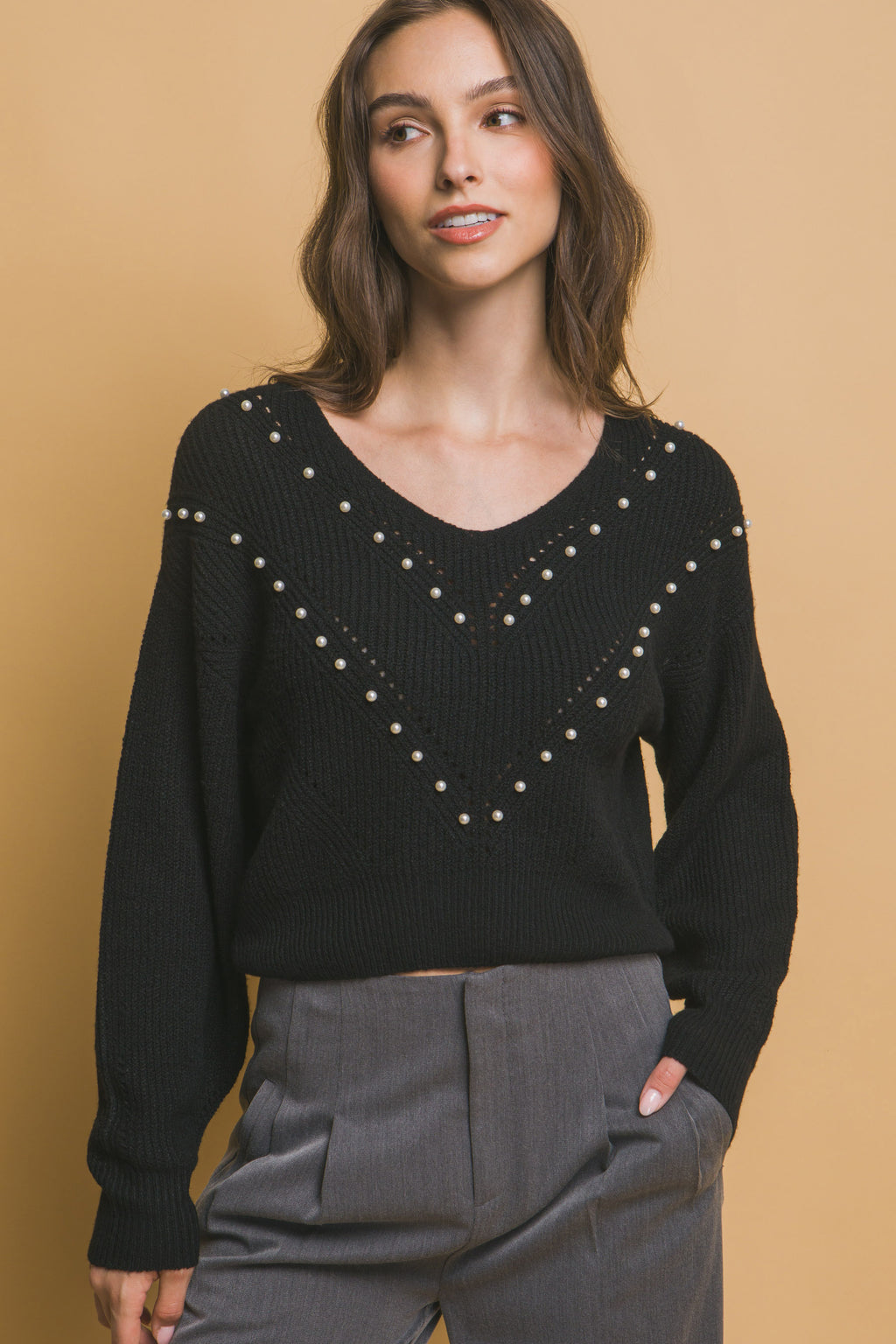 Black pearl-embellished V-neck knit sweater with long sleeves and bead chevron
