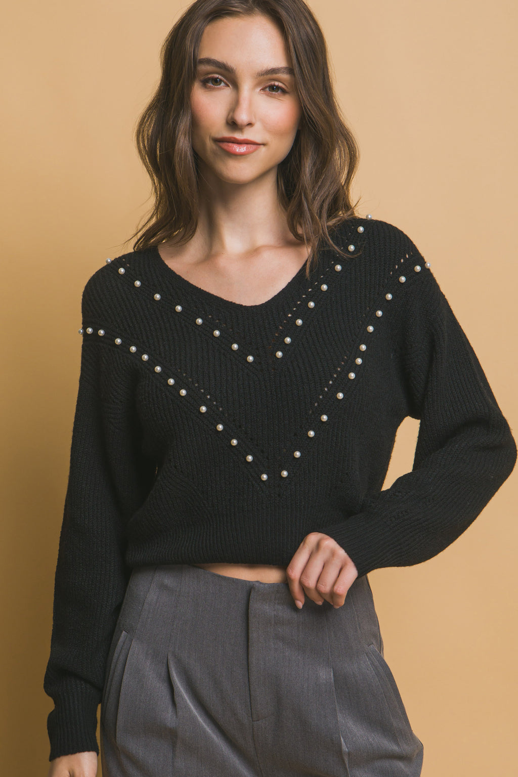 Black pearl detail V-neck knit sweater, long sleeves, close-up of bead pattern