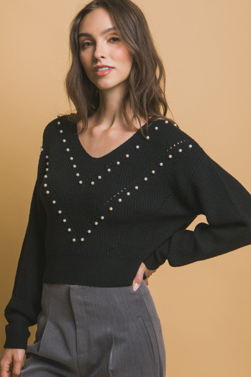 Black pearl detail sweater with faux-pearl embellishments on V-neck