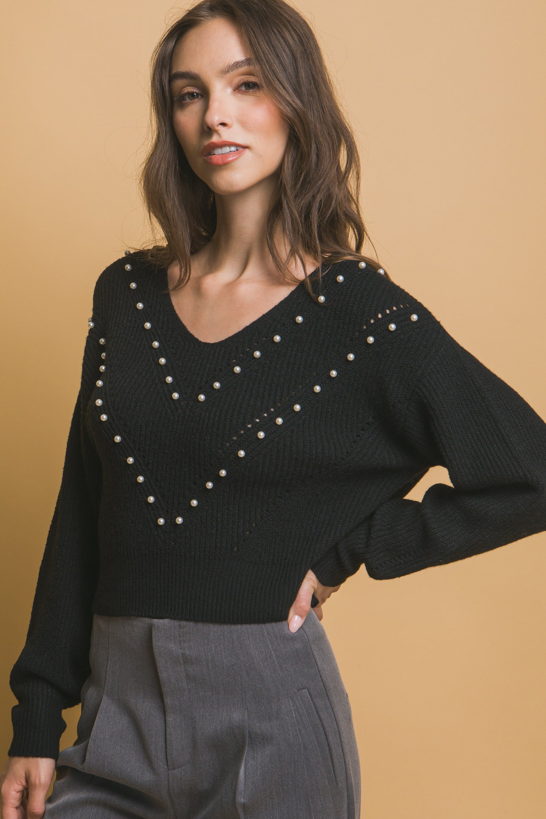 Black pearl detail sweater with faux-pearl embellishments on V-neck