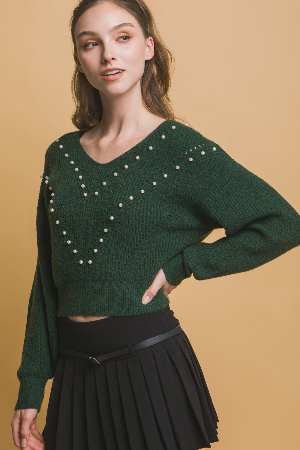 Dark green long-sleeve sweater with pearl-trim chevron pattern