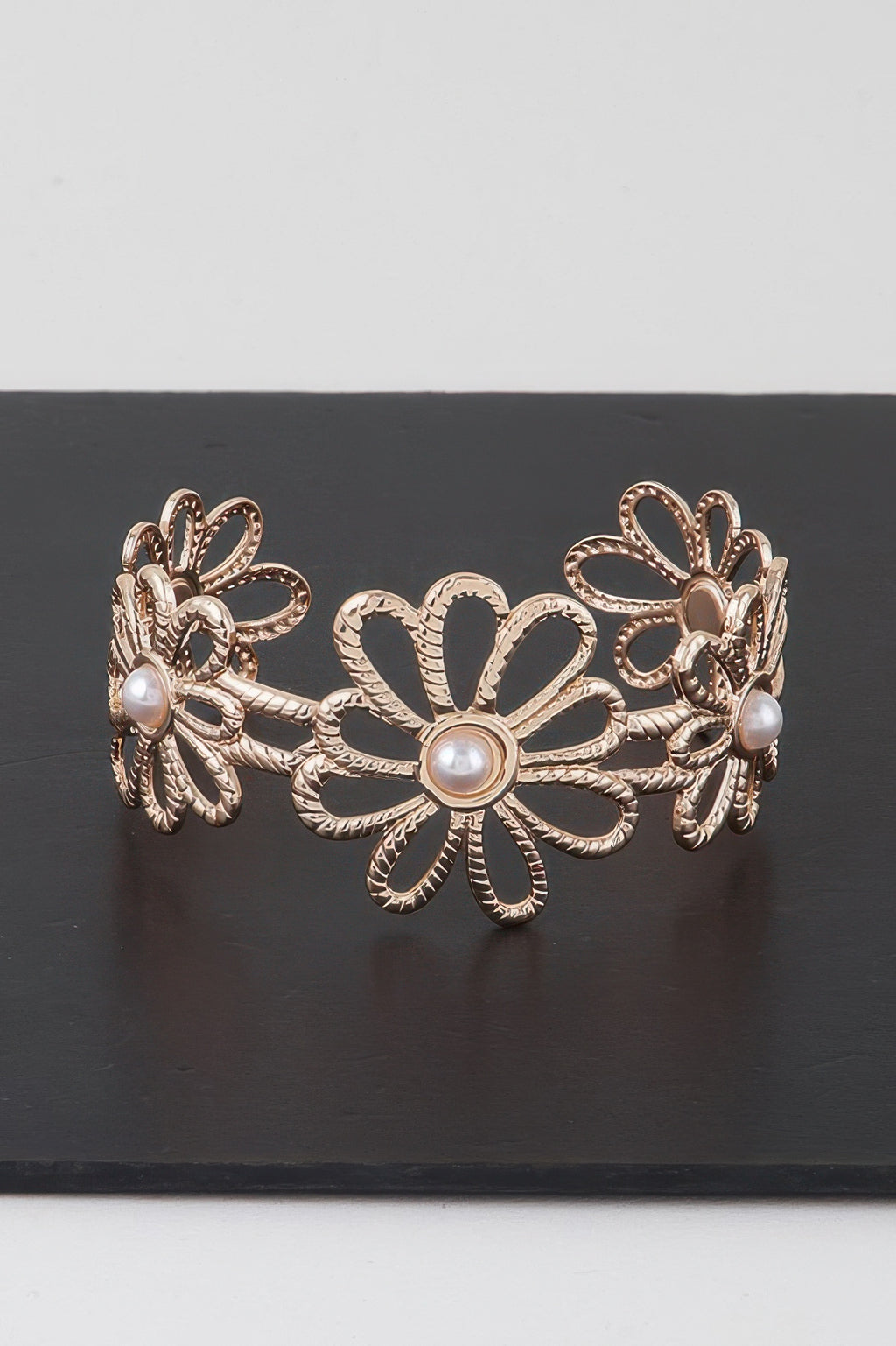 Gold-tone pearled flower cuff bracelet with daisy center and pearl accents