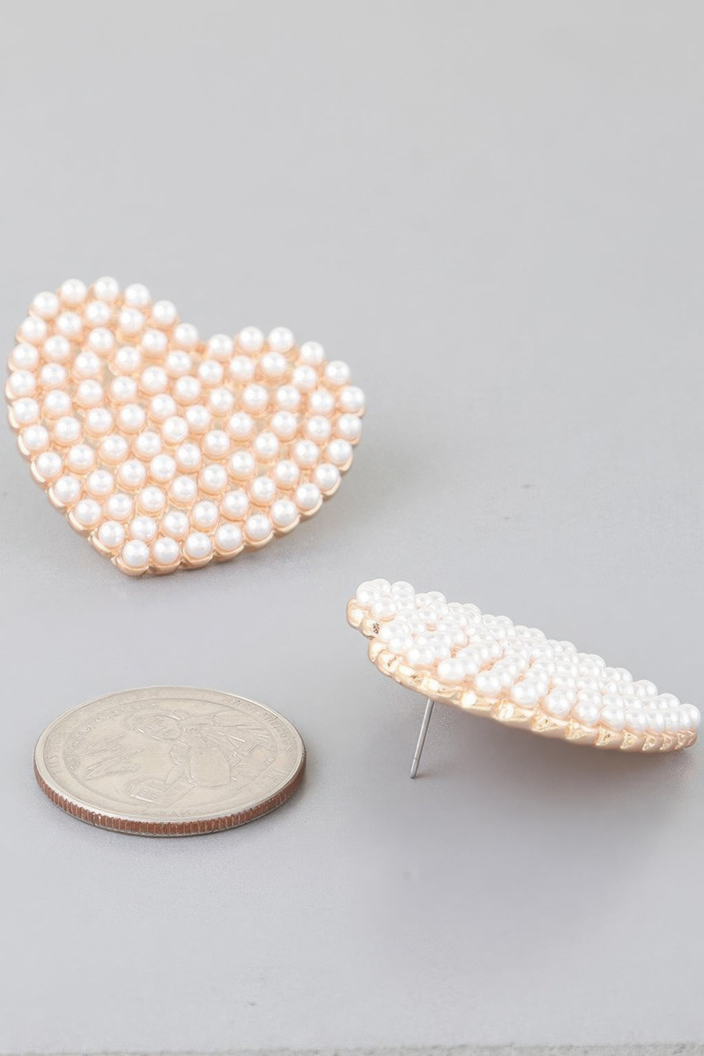 Single cream pearl heart stud earring, gold-tone back post visible