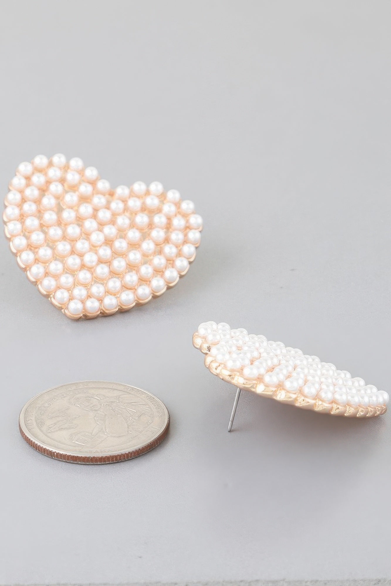 Single cream pearl heart stud earring, gold-tone back post visible