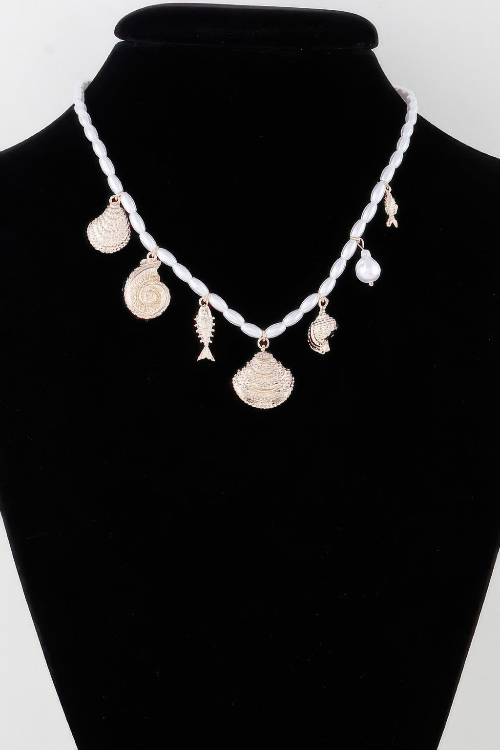 Pearled Under The Sea charm necklace with white bead chain and gold seashell pendants