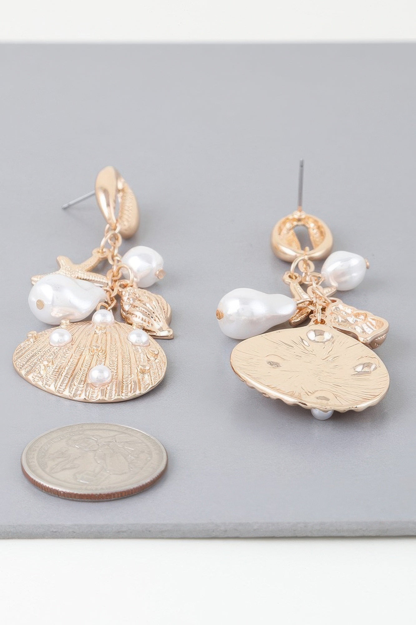 Gold-cream undersea drop earrings with starfish, white pearls, shell-disc charms