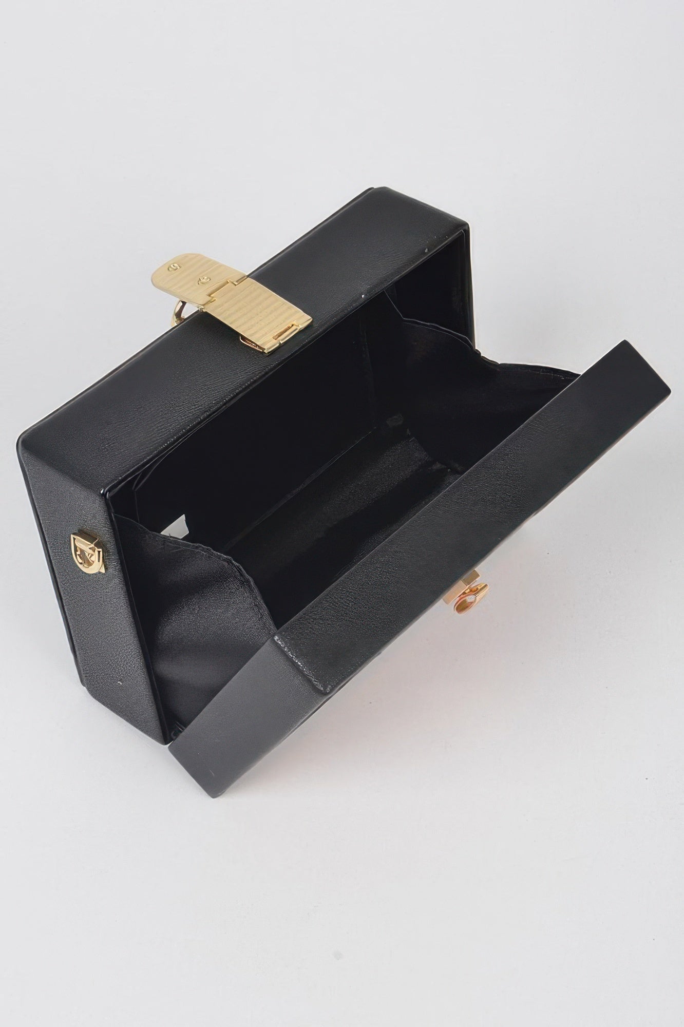 Open black pencil case clutch with key lock hardware and empty interior
