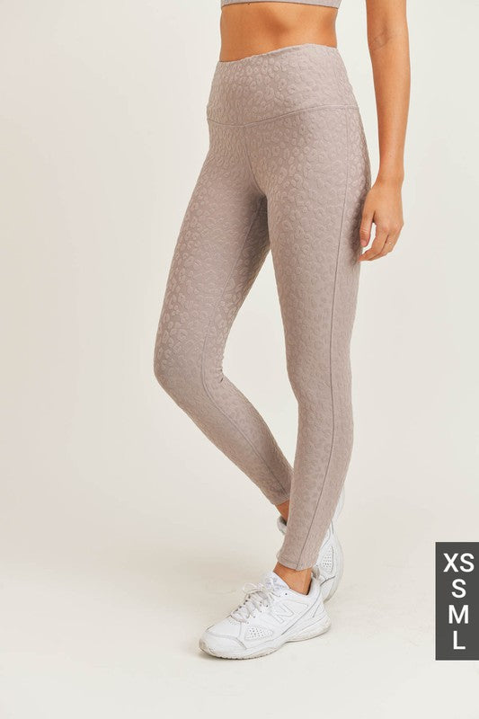 Side view: high-rise light taupe petit leopard jacquard leggings with slim tapered legs