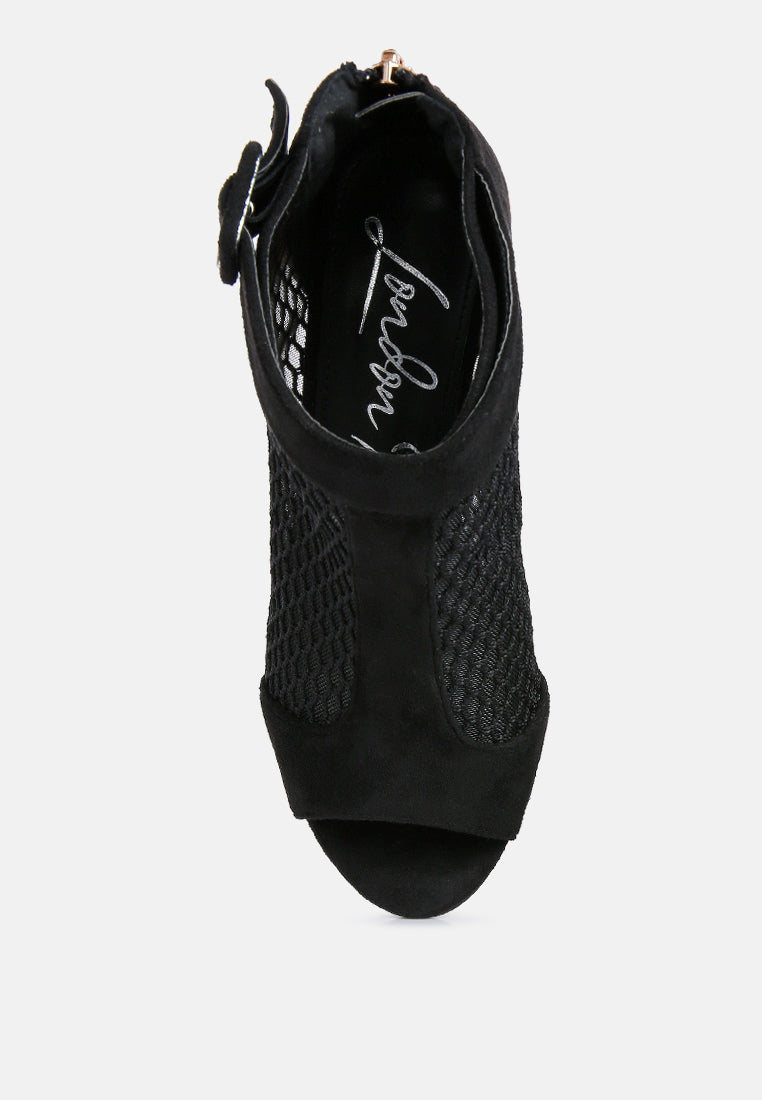 Black open-toe shoe with textured design on a white background