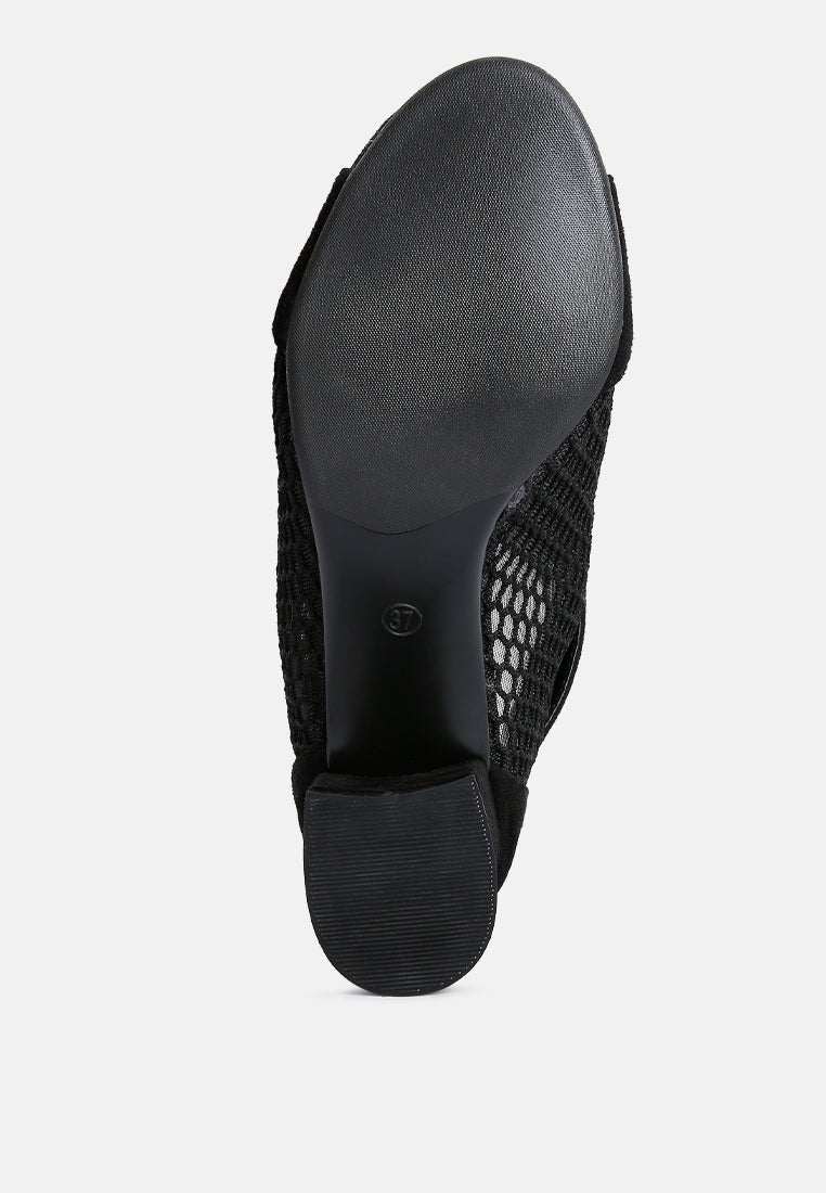 Black shoe with mesh design on a white background