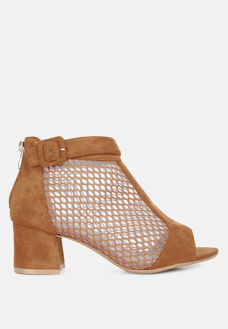 Tan suede shoe with mesh design on a white background