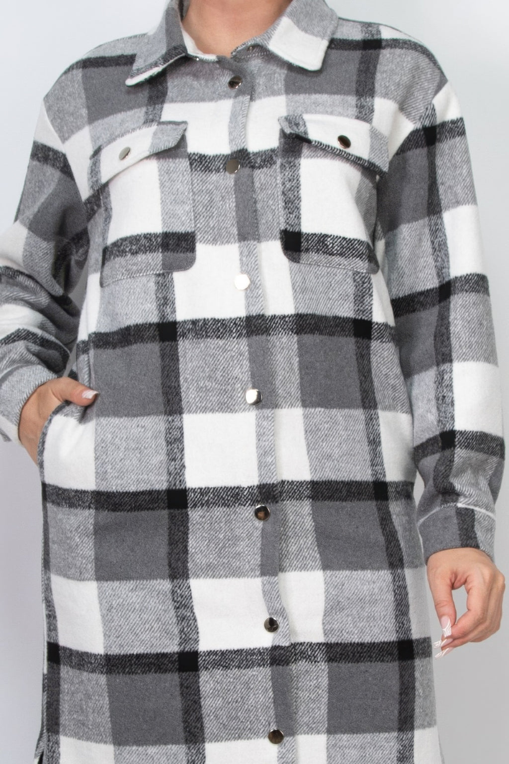 Close-up plaid shacket coat: black-and-white check pattern, button front and flap pockets