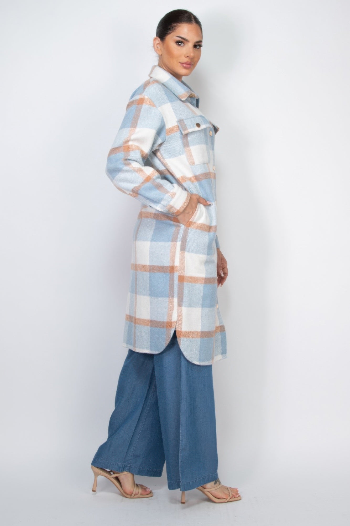 Side view of light blue and orange plaid shacket coat with button front