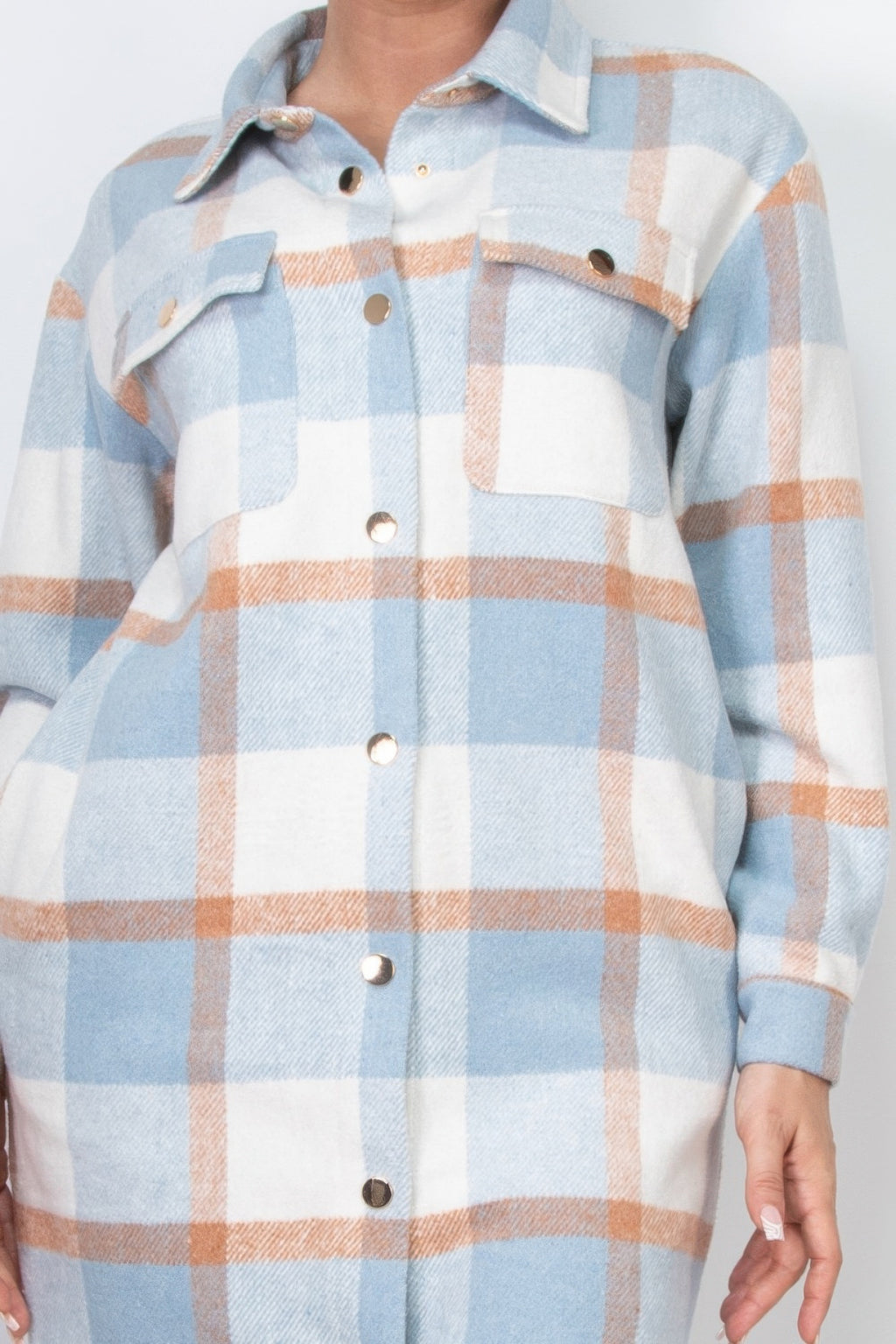 Close-up light blue plaid shacket coat: button front and flap chest pockets
