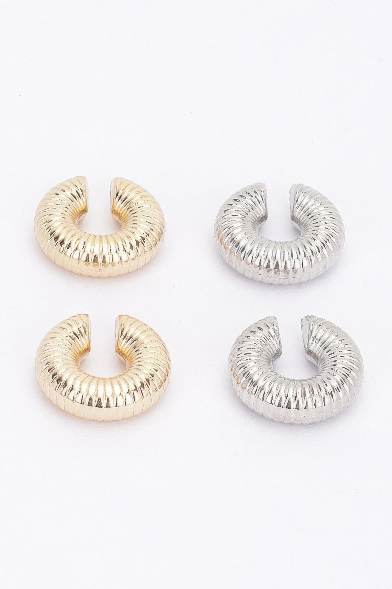 Assorted plastic cuff hoop earrings: gold and silver ridged spiral styles