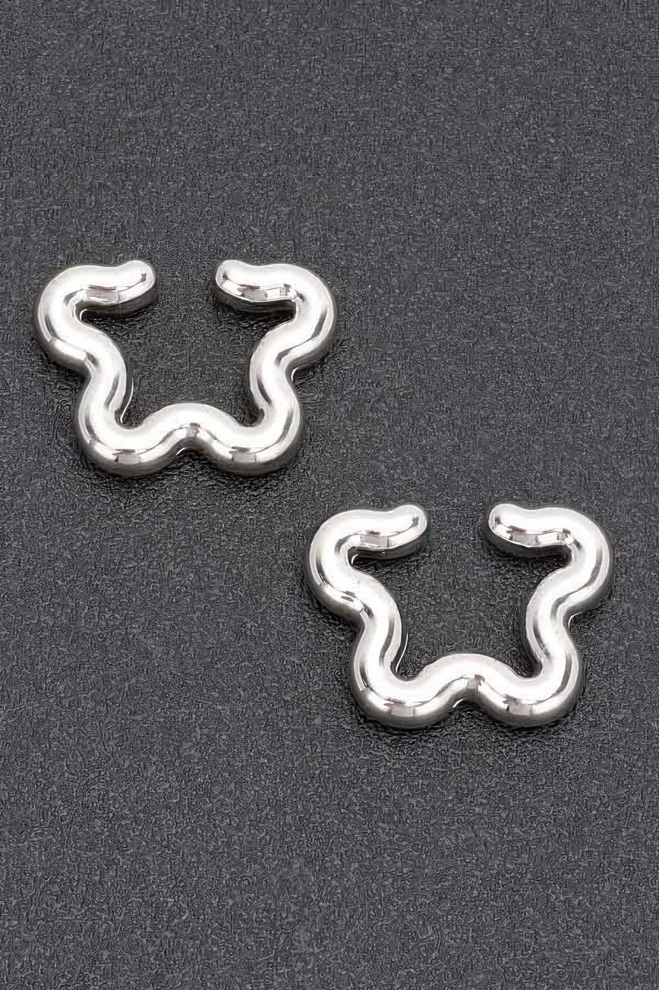 Silver plastic cuff earrings, wavy snake-like open cuff design