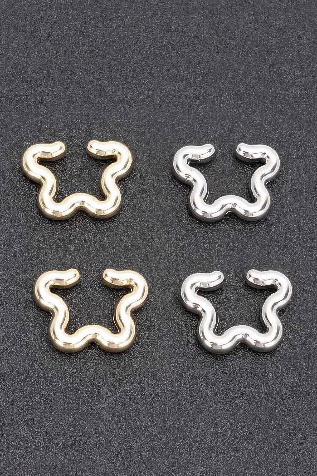 Plastic cuff earrings set: gold and silver pairs with wavy snake-shaped design