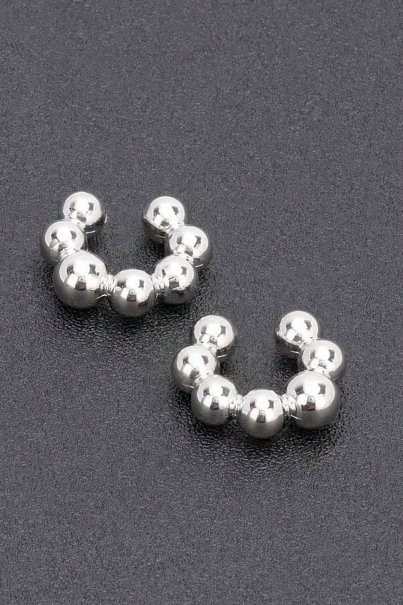 Silver plastic cuff hoop earrings with rounded bead spheres, pair