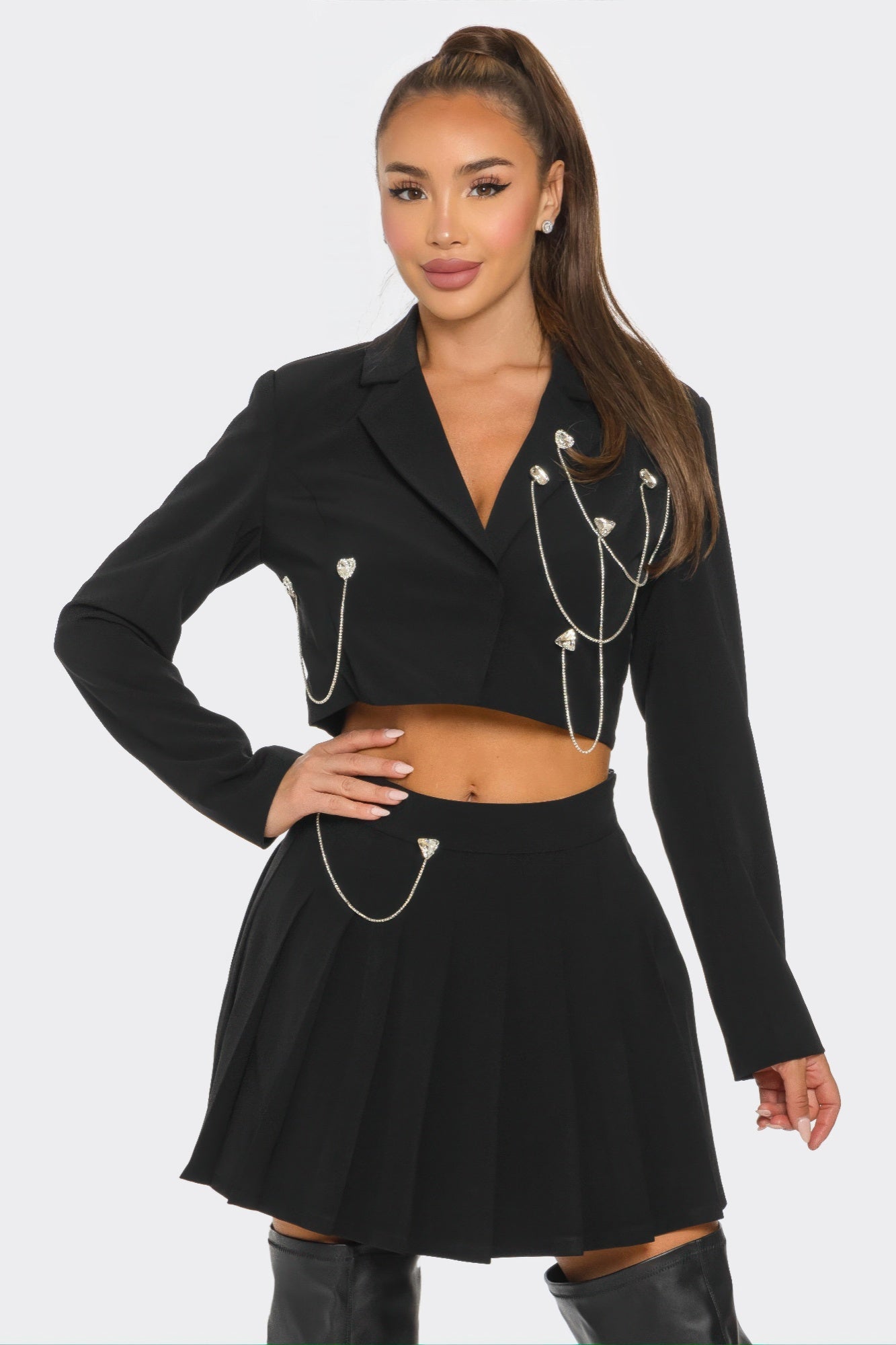 Black pleated skirt set with cropped blazer and dangling silver chain decorations