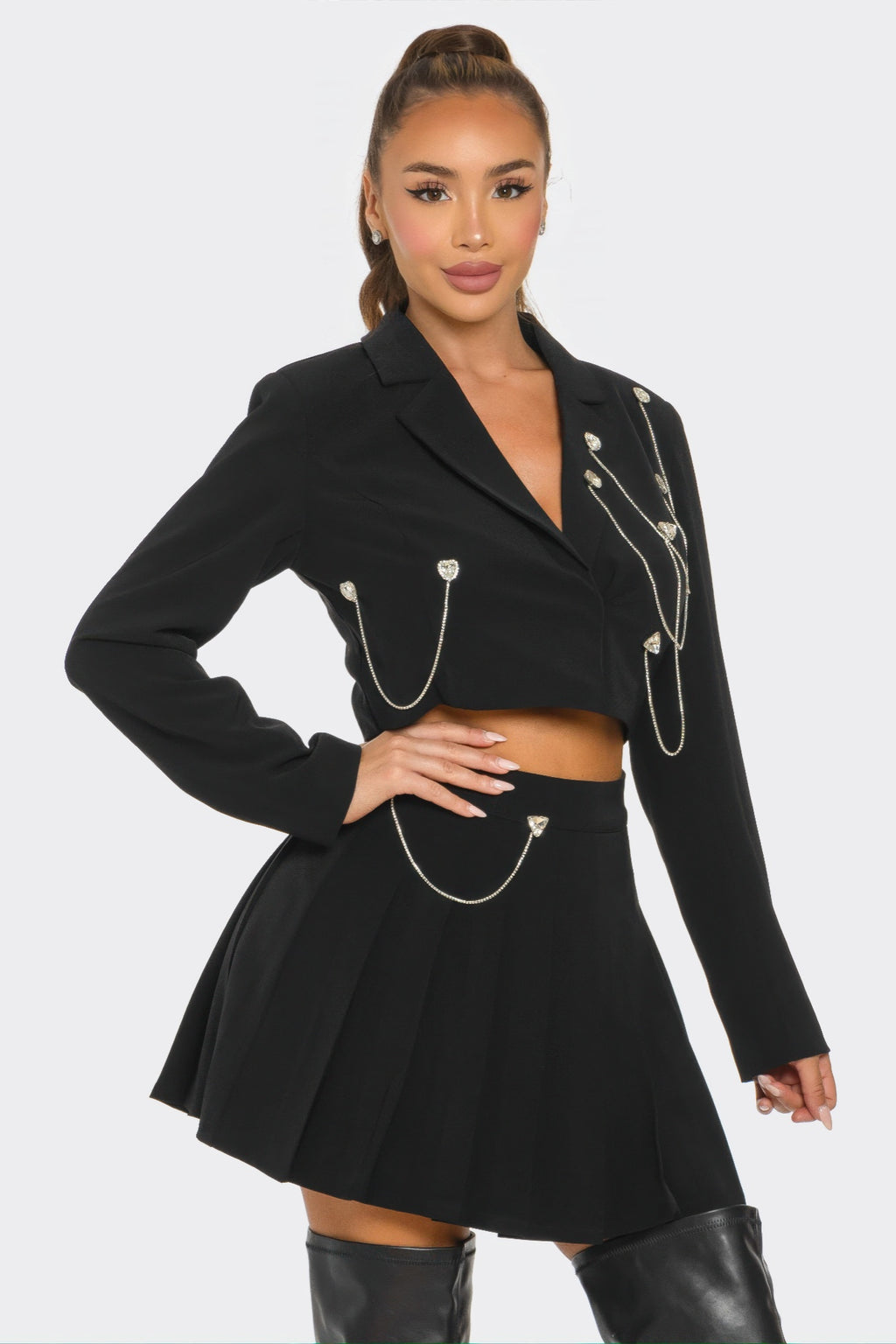 Black pleated skirt set with cropped blazer and silver charm chains on lapels