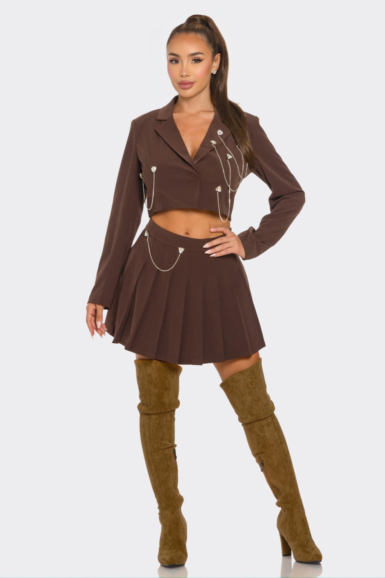 Chocolate-brown pleated skirt set: cropped blazer with chain trim and pleated mini skirt