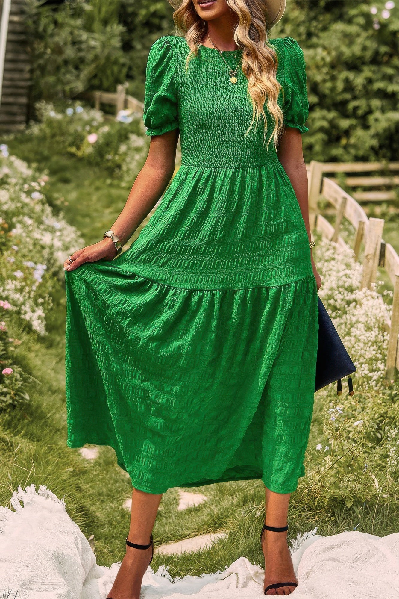 Tiered A-line dress in green with short puff sleeves and pleated skirt tiers