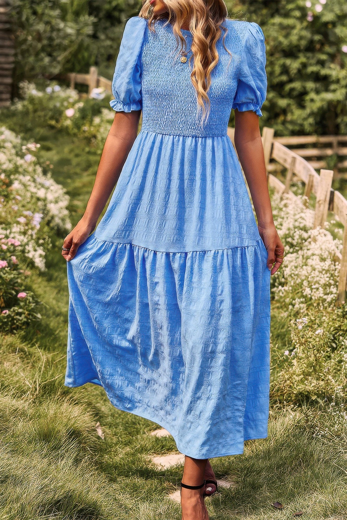 Blue tiered A-line dress with short puff sleeves and layered pleated skirt