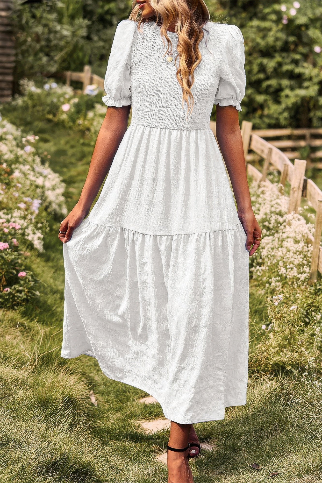 White tiered A-line dress with short puff sleeves and layered pleated skirt