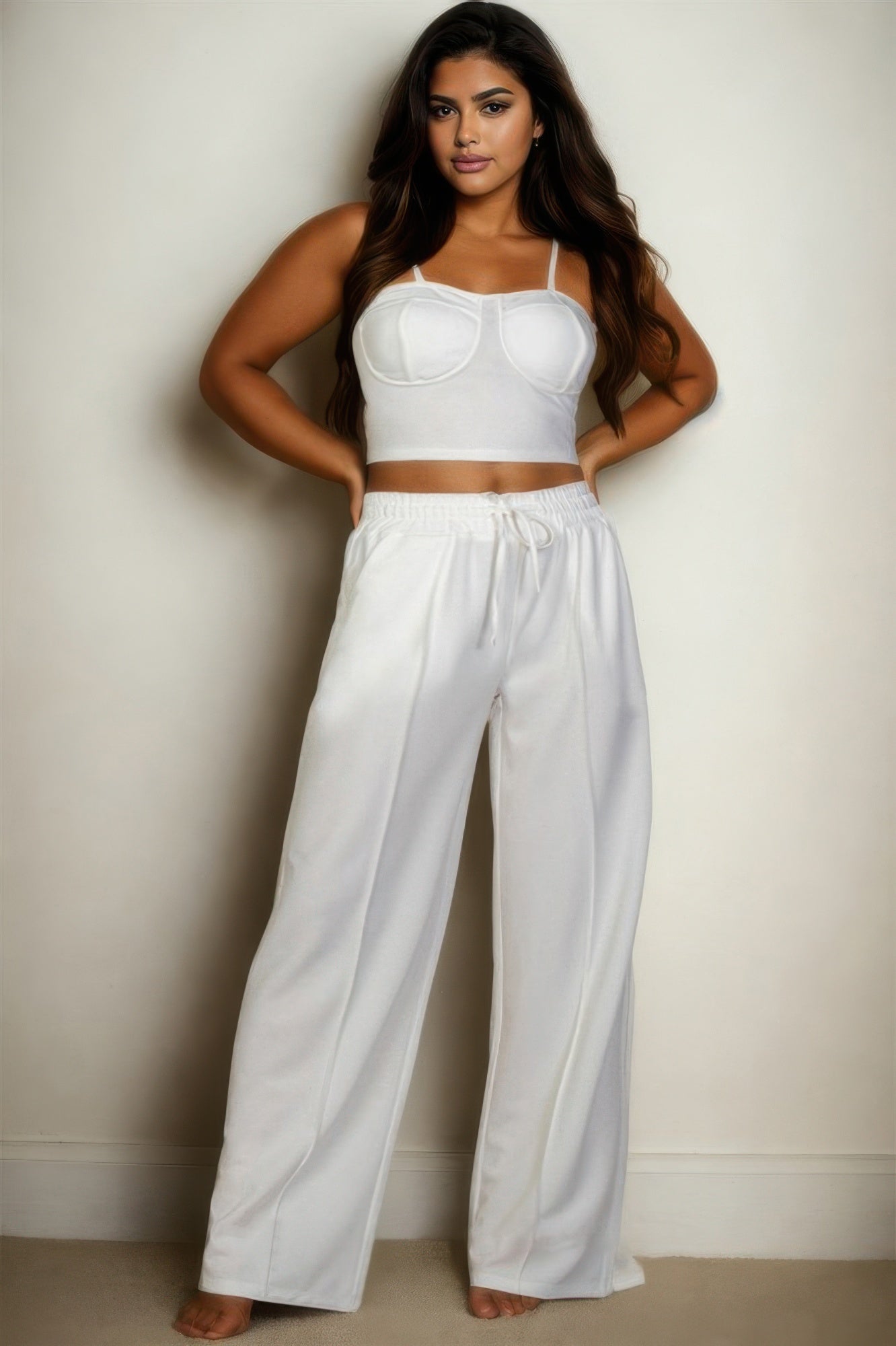 White bustier crop cami top with spaghetti straps and wide straight pants, plus-size
