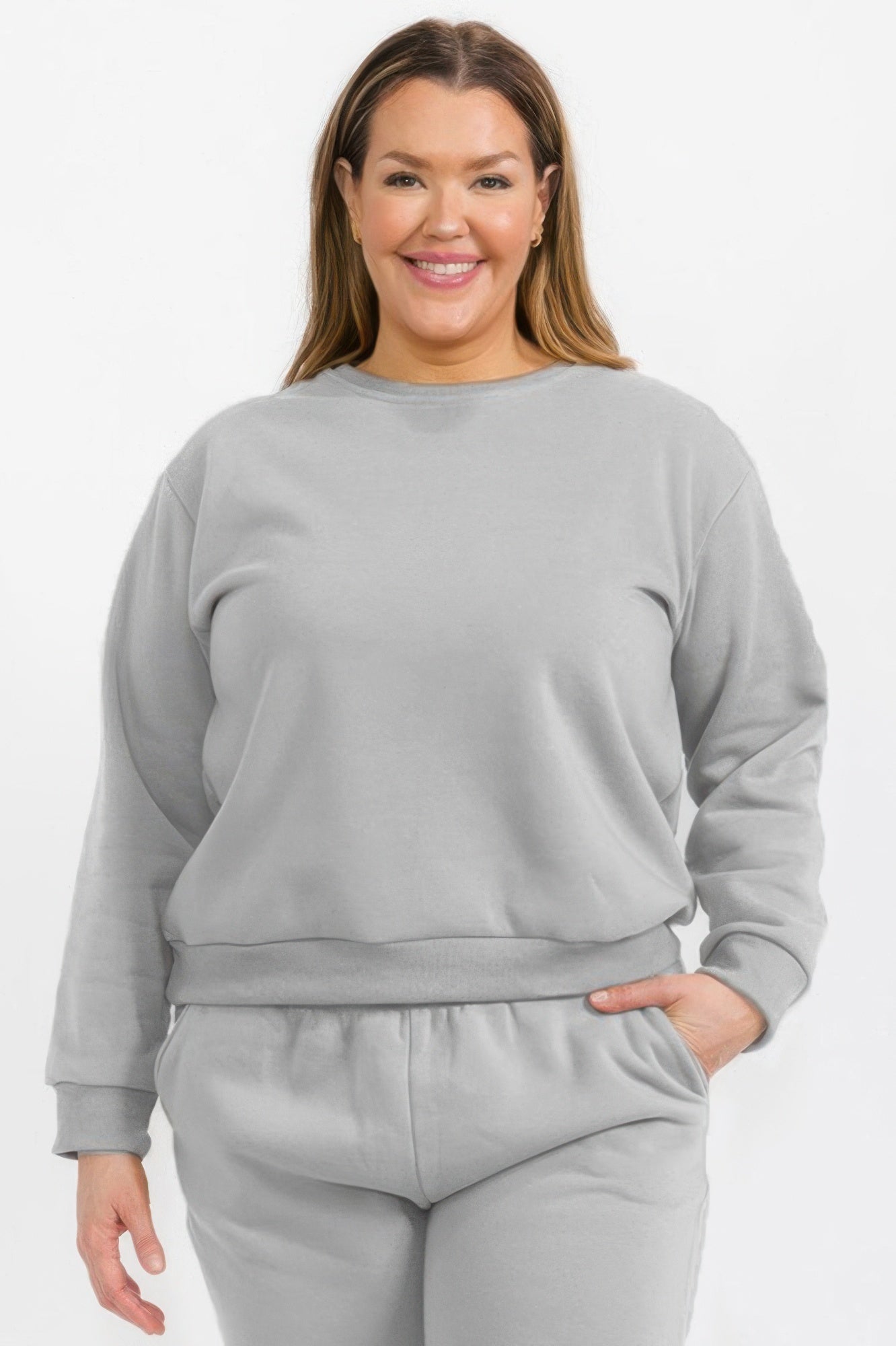 Plus size crewneck pullover in heather grey fleece with long sleeves and ribbed hem