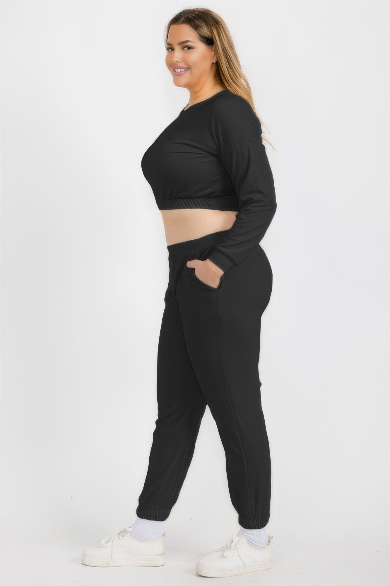Black pullover and joggers set, side view; elastic waist and ankle cuffs