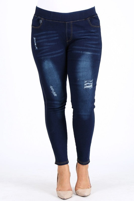 Medium blue plus size high-waist denim jeggings with ripped details, back view