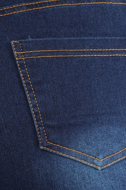 Close-up of medium blue denim jeggings: front pocket and golden contrast stitching
