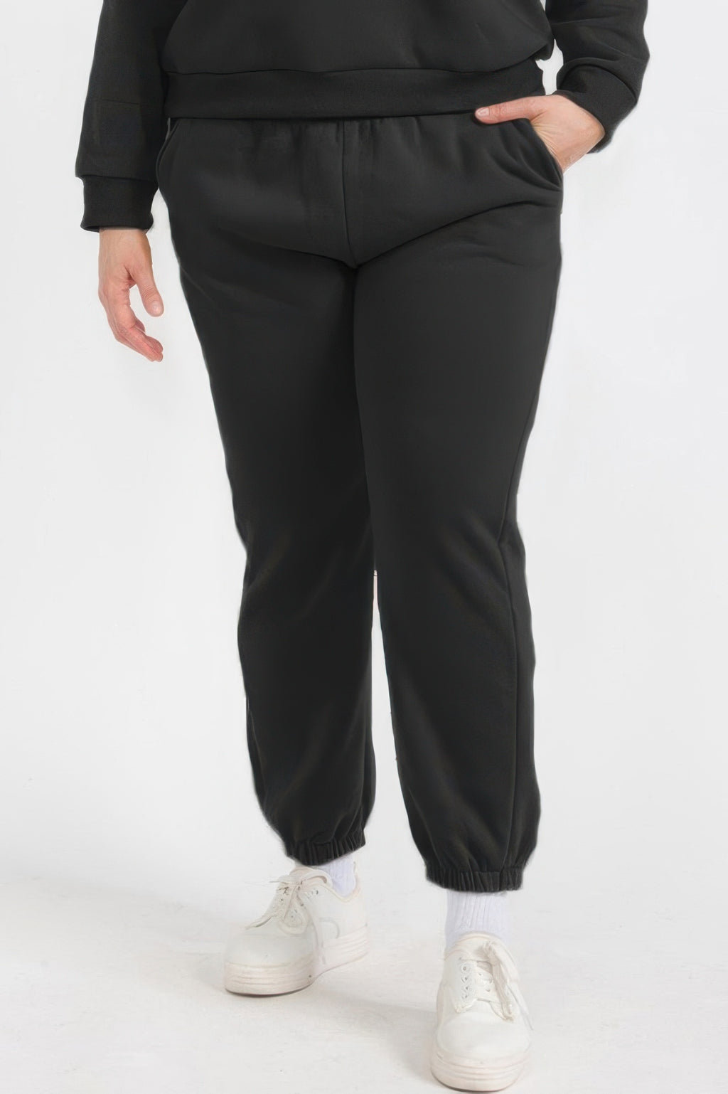 Plus size poly fleece joggers in black with elastic waistband and cuffed ankles