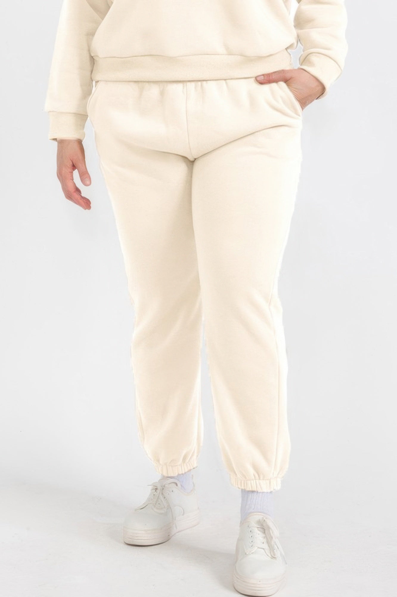 Plus size joggers in stone/cream color with elastic waistband and cuffed ankles