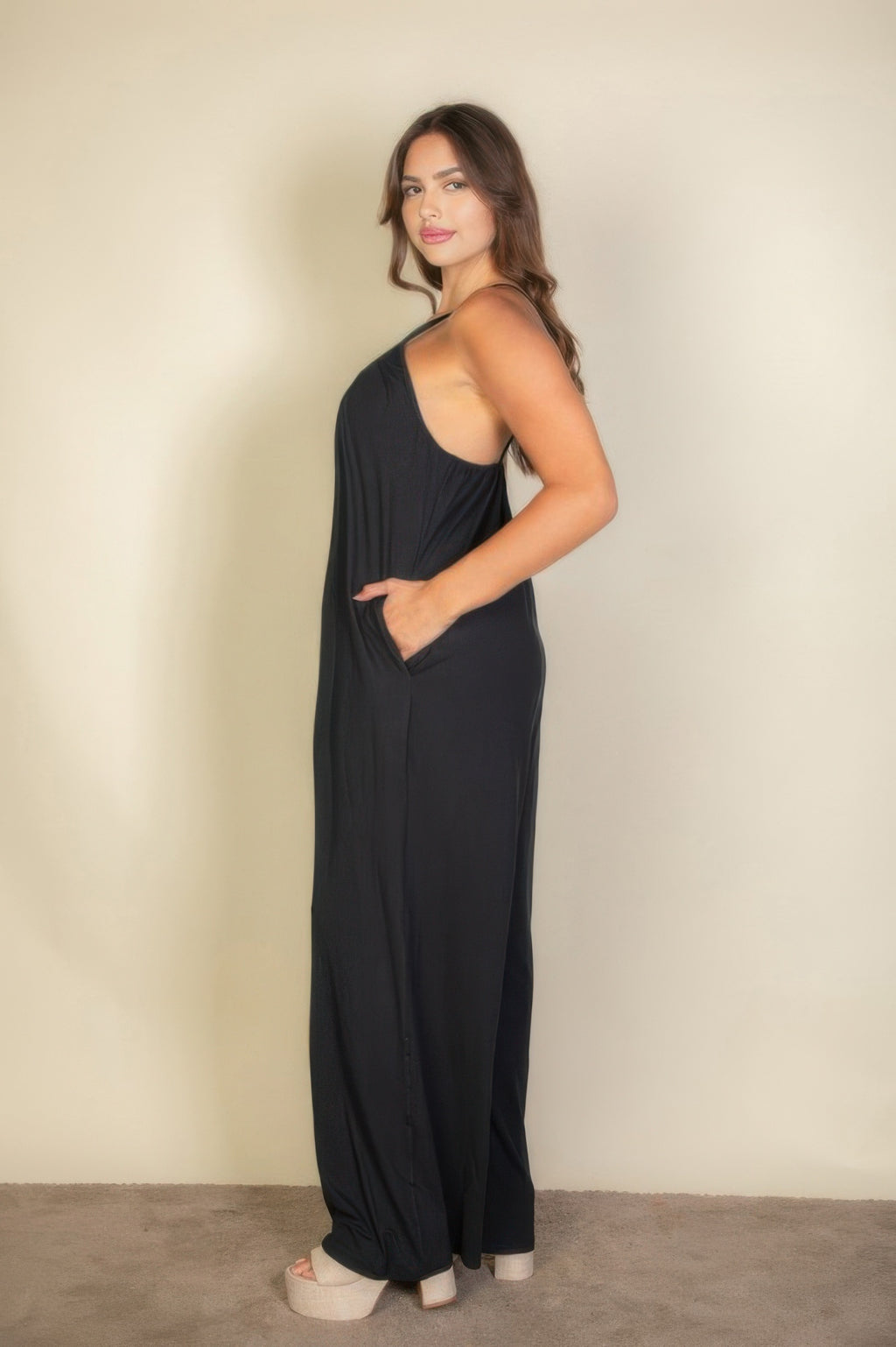 Plus solid wide-leg jumpsuit with spaghetti straps, relaxed drape in dark color