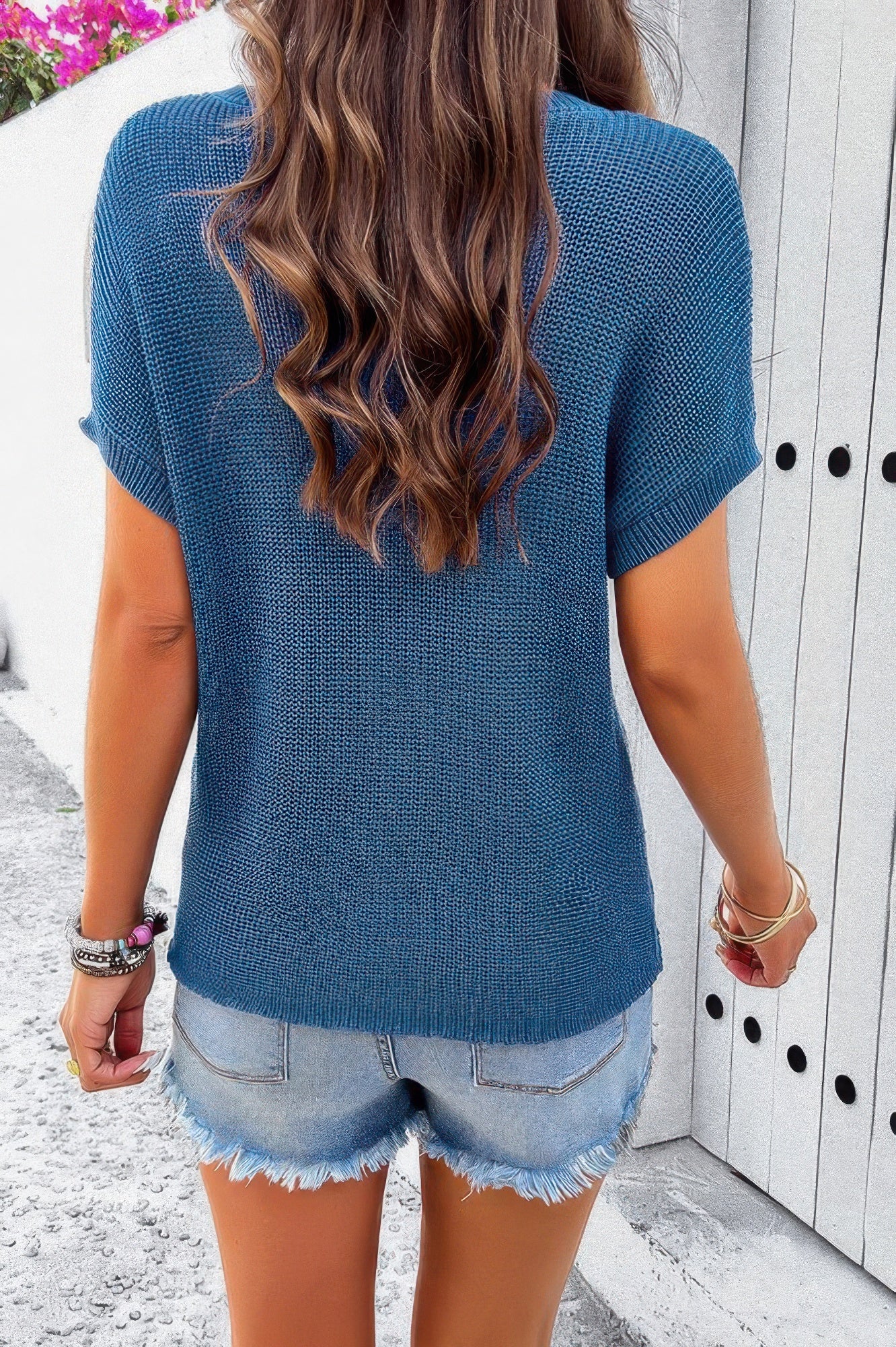 Blue loose knit crewneck sweater, short sleeves (back)