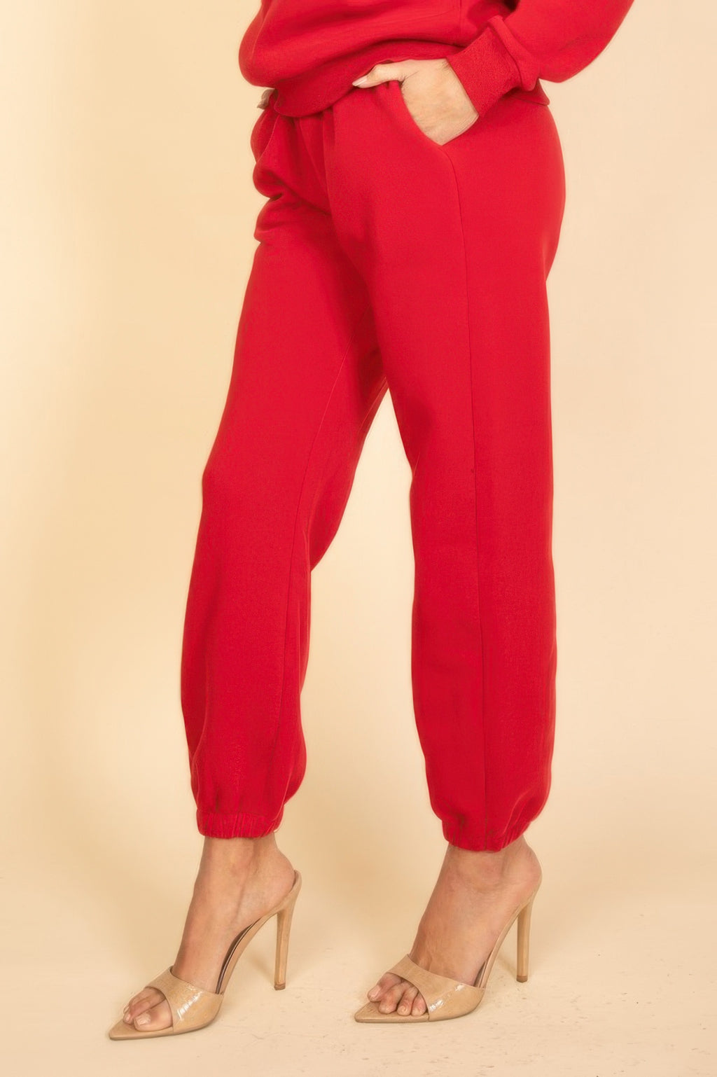 Red joggers side view, relaxed leg and elastic cuffed ankles