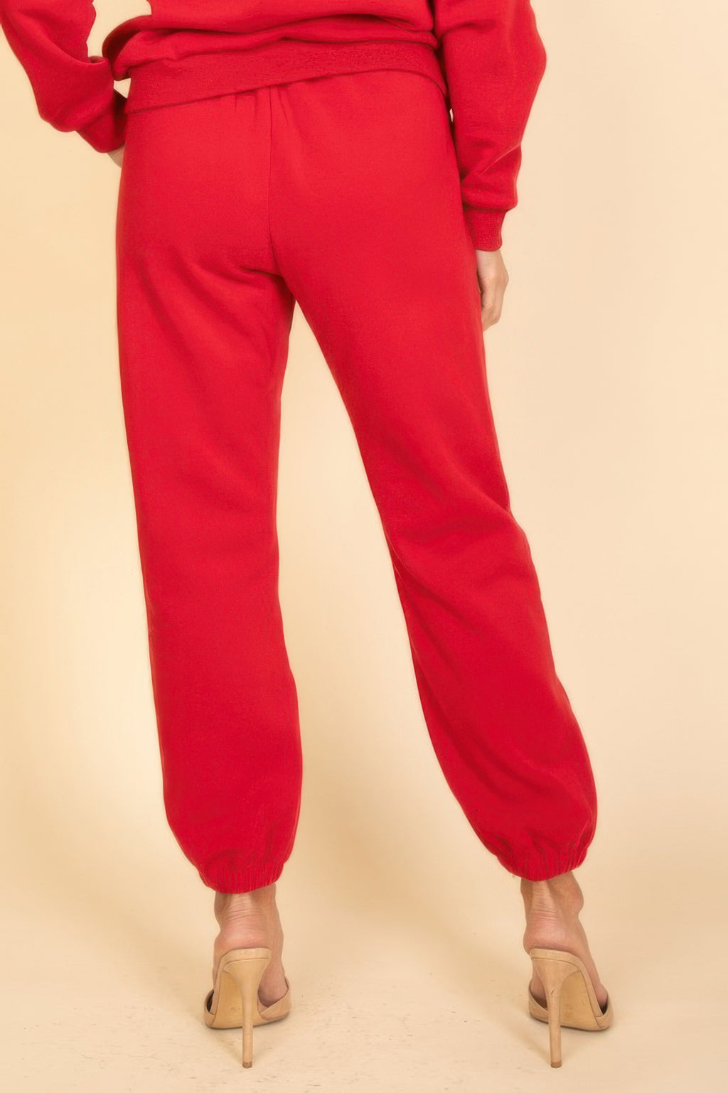Red poly fleece joggers with elastic waistband and ankle cuffs