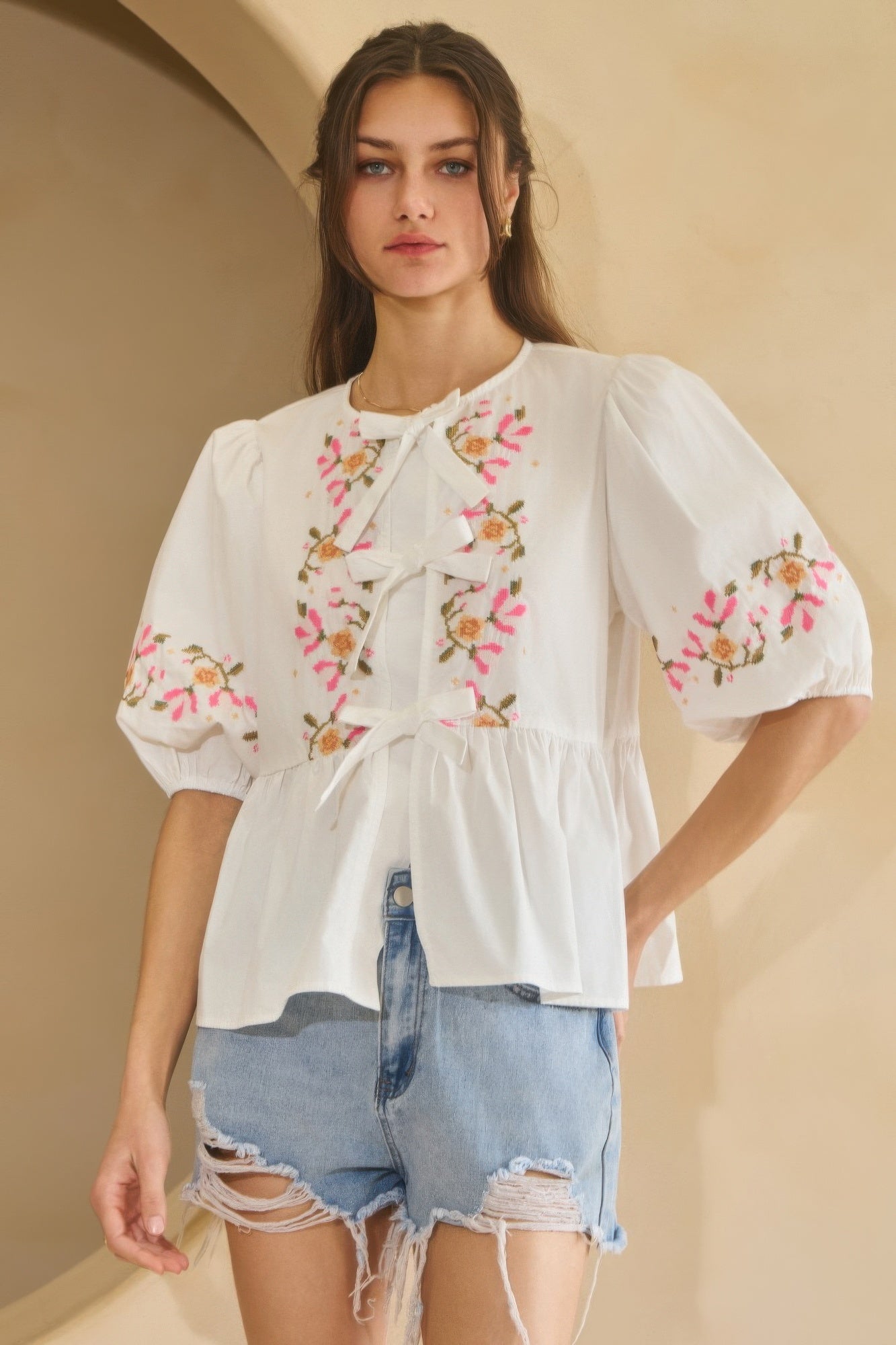 Poplin blouse in off-white with front ribbon tie and floral embroidery on sleeves and yoke