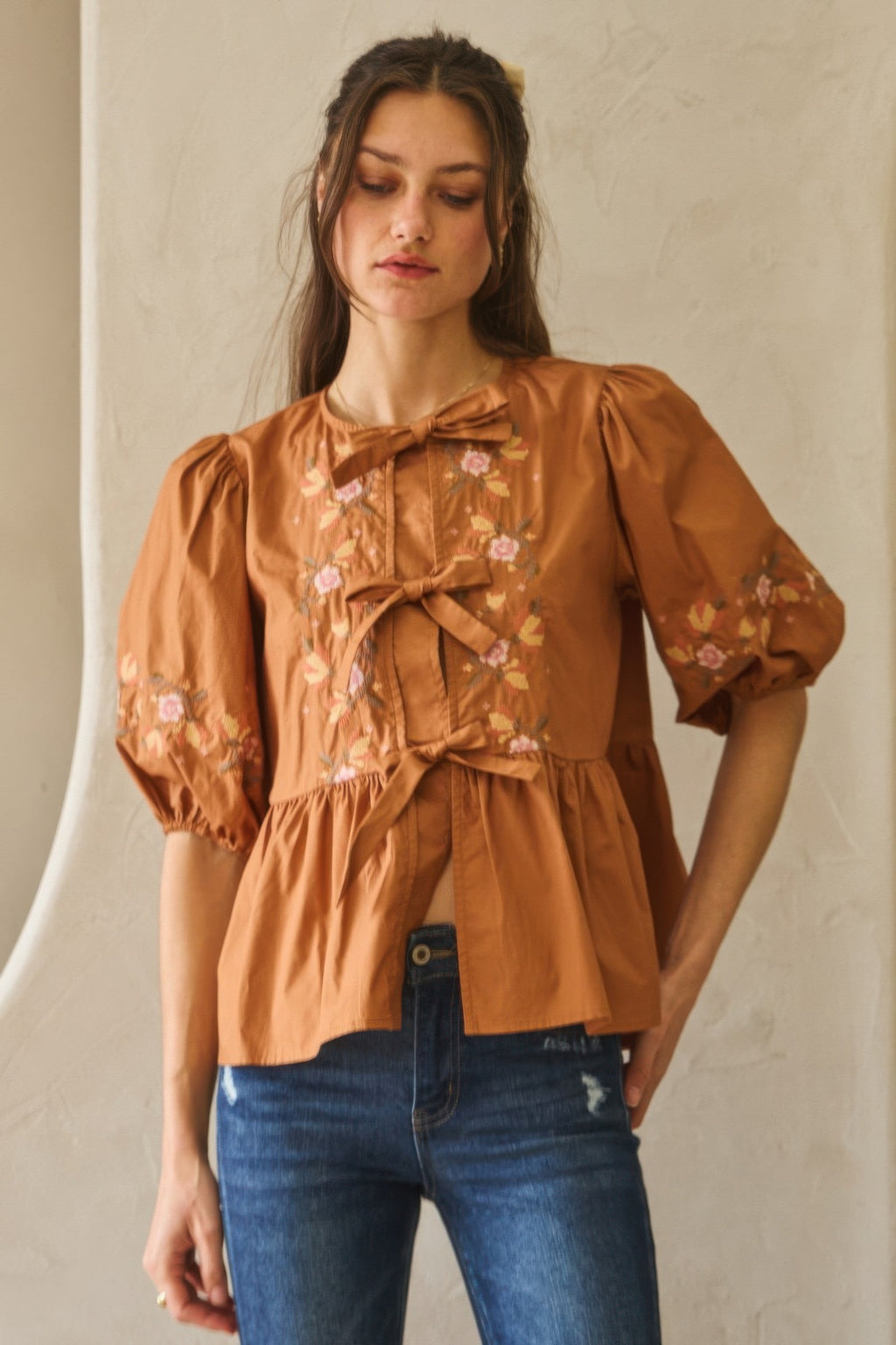 Chesnutt brown poplin blouse with front ribbon tie and puff sleeves with florals