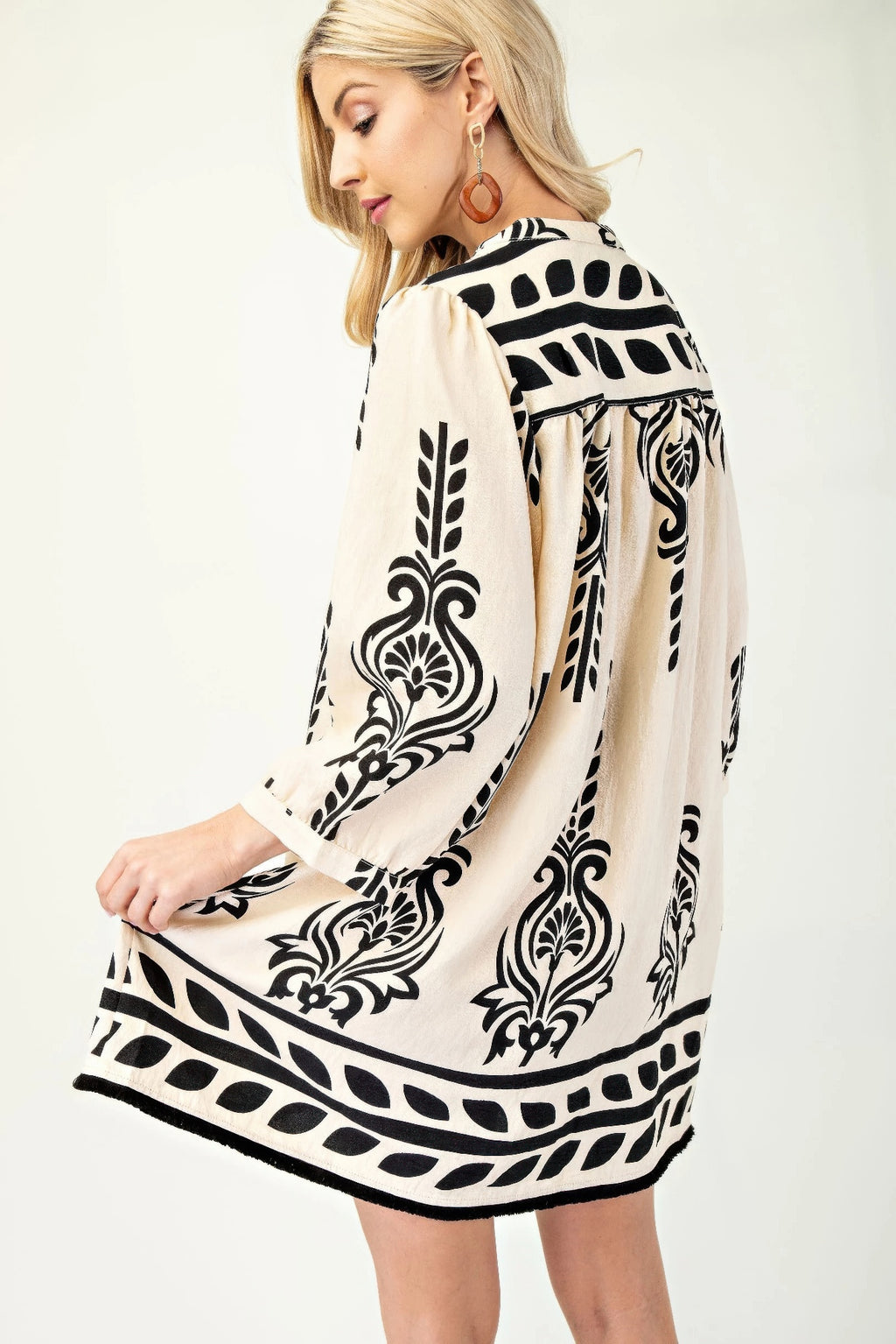 Back view of cream dress with black damask print and 3/4 sleeves