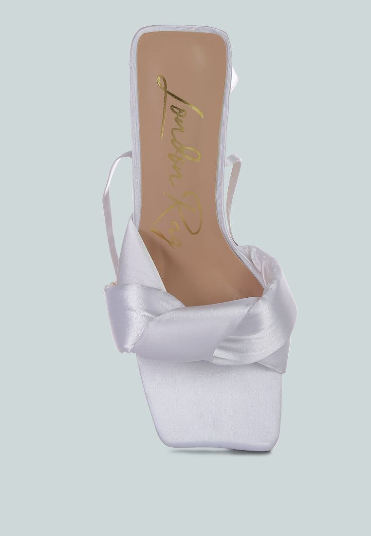 White satin block heel sandal, thick twisted knot straps across the front
