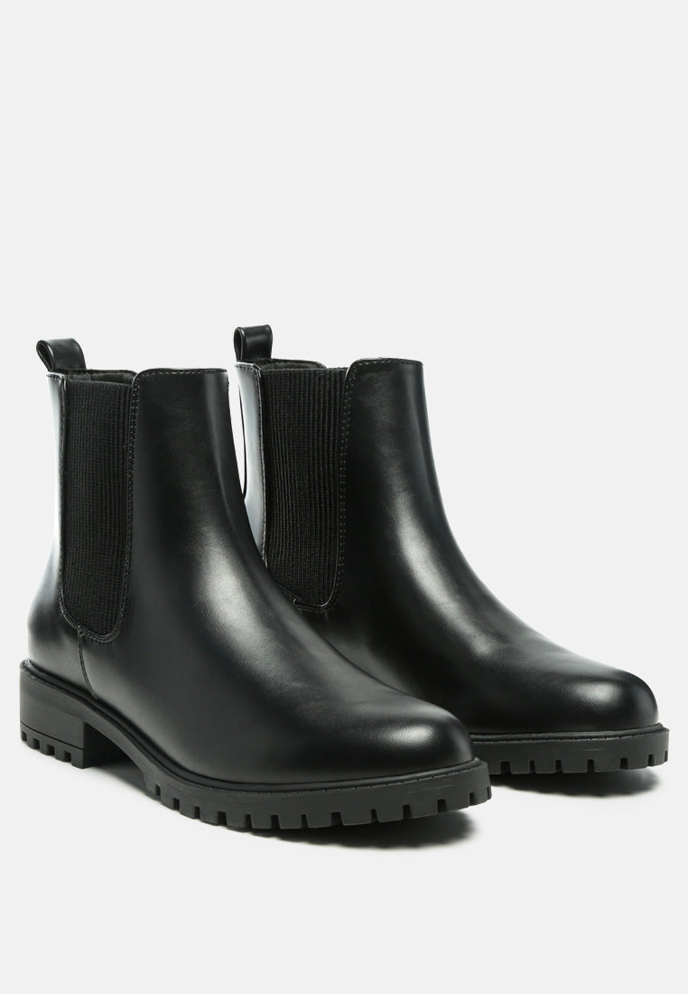 Black Chelsea ankle boots pair with elastic side panels and thick lug outsole