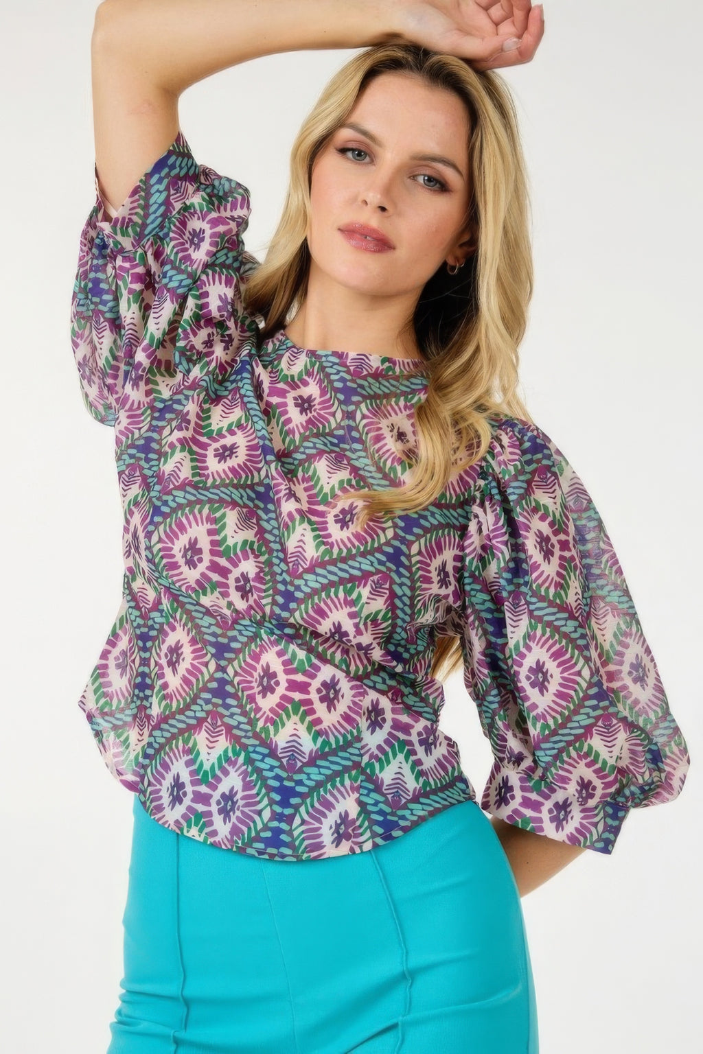 Colorful puff sleeve top with allover purple/green/teal print and crew neck