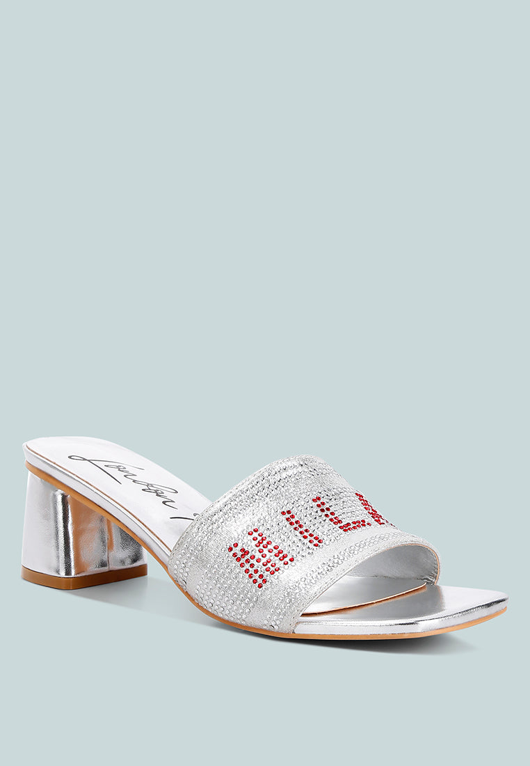 Silver slide sandals with rhinestone embellishment and metallic block heel